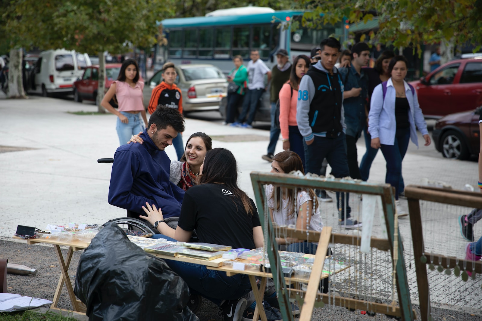 people sitting on brown wooden bench during daytime