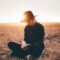 person in black sweater opening book